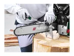 A person wearing gloves uses a file to sharpen a chainsaw chain secured in a stump vice.