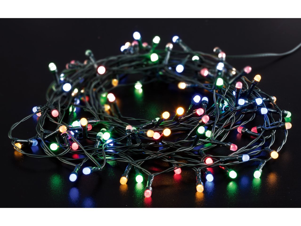 Multicolor LED string lights, coiled on a dark surface, glowing brightly.