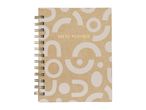 A spiral-bound study planner with a light brown cover featuring abstract white shapes and gold text.