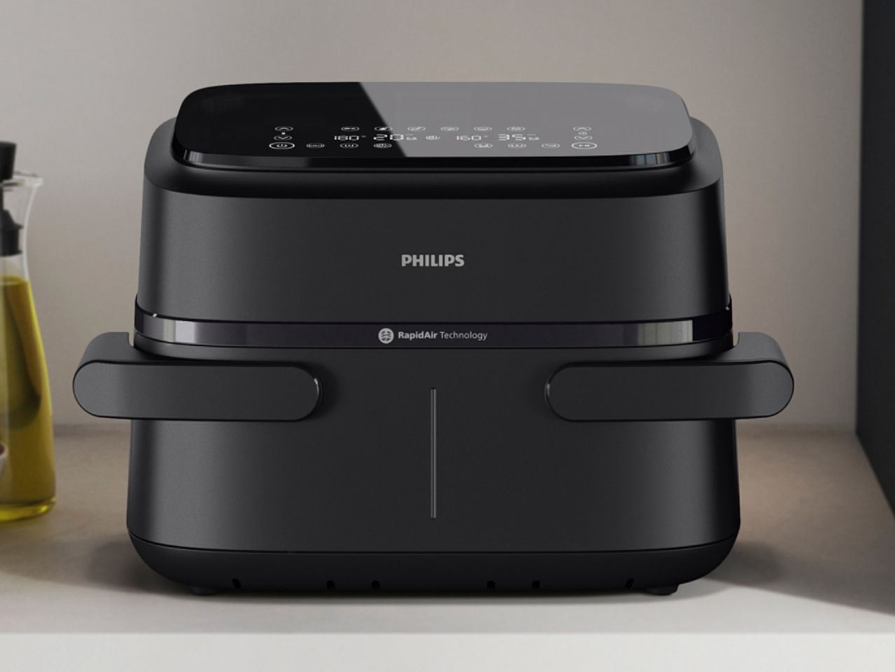 Black air fryer with a digital display showing temperature and time settings, on a kitchen counter.