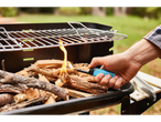 Lighting wood in a grill with a BIC lighter.