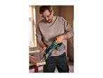 Man wearing safety glasses and earplugs, cutting wood with a reciprocating saw.