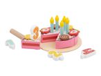 Wooden toy birthday cake with candles, fruit toppings, and number pieces.