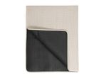 Folded beige and black picnic blanket