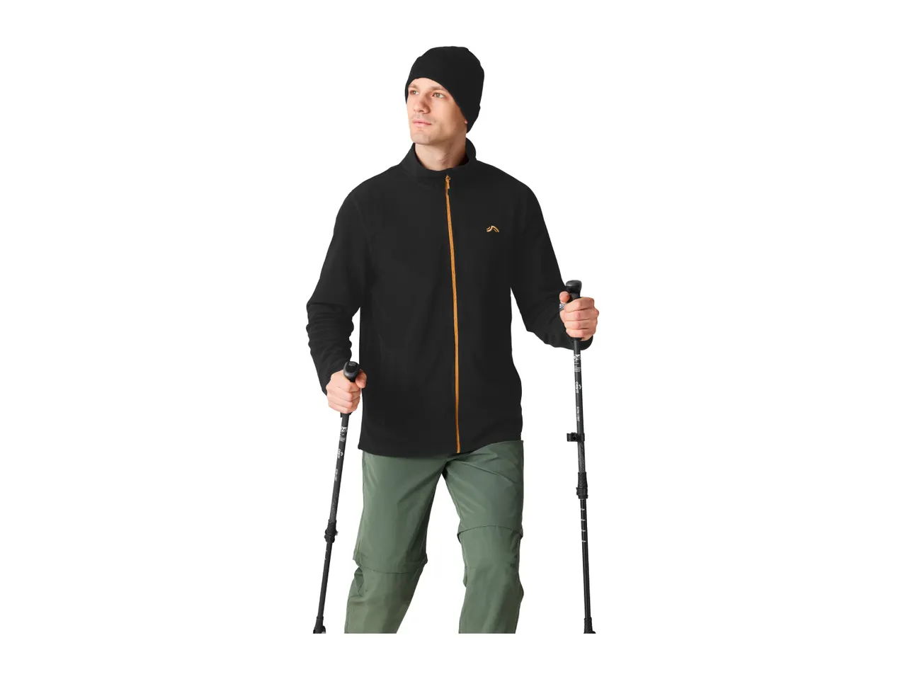 A man in a black fleece jacket, green trousers and a beanie holding trekking poles.