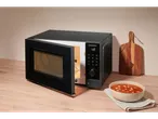 SilverCrest microwave with open door and soup on a wooden table