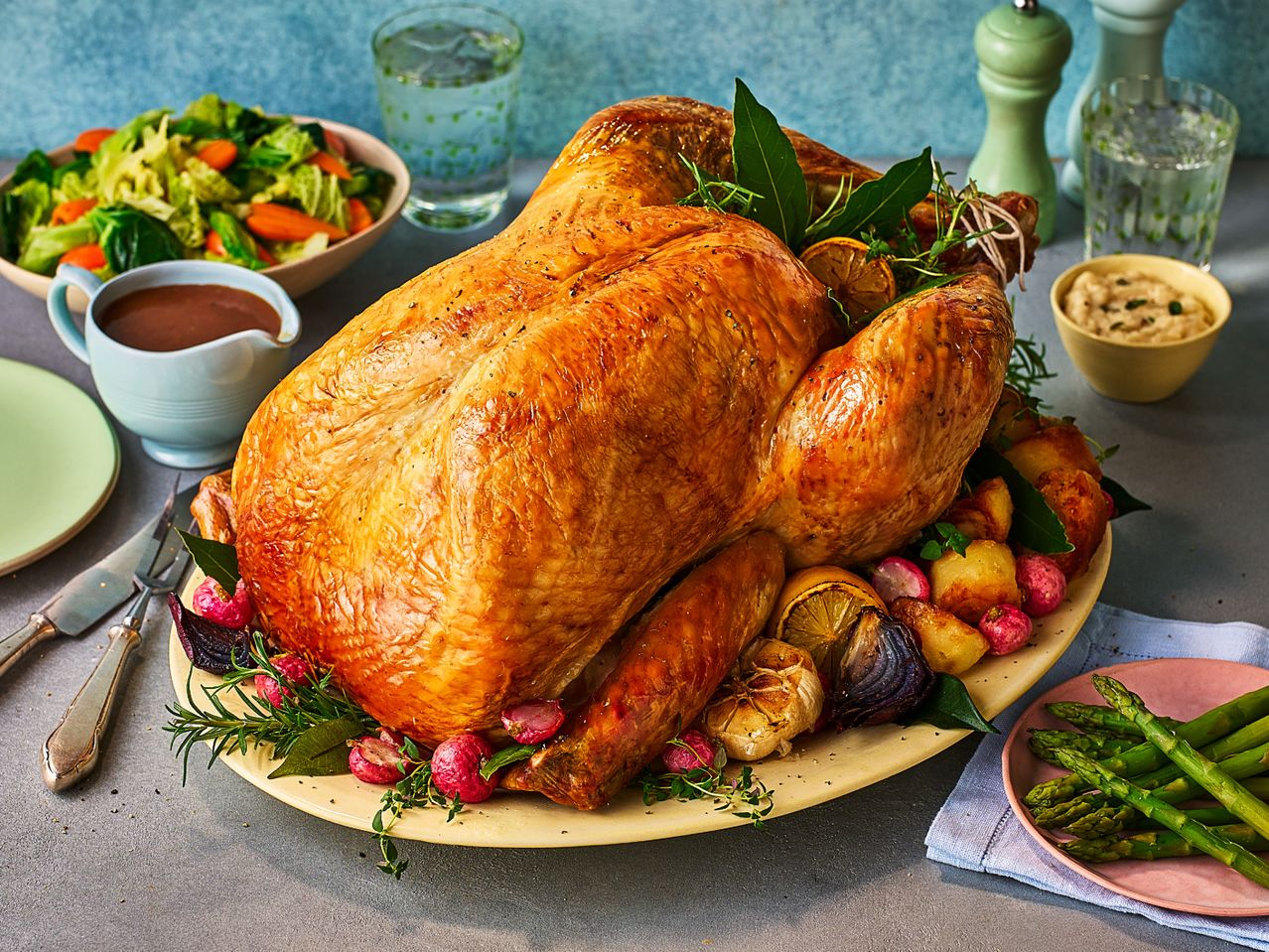 A roasted turkey with gravy, vegetables, and sides, ready for a festive meal.