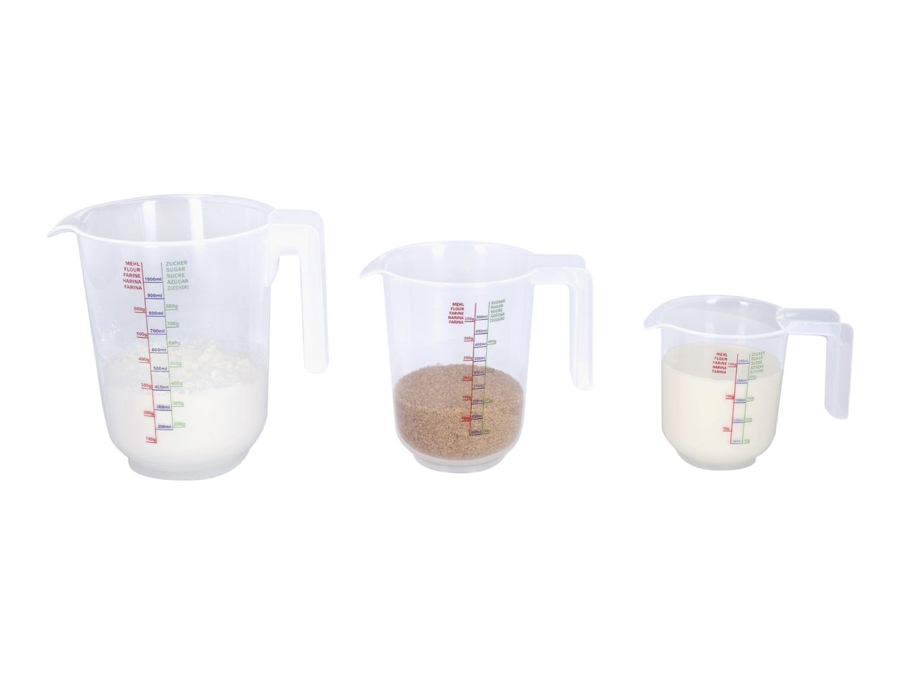 Three transparent measuring jugs of different sizes, filled with flour, brown sugar, and milk.