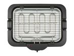 Electric table grill with a metal grate and heating elements, top-down view.