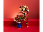 A single red rose in a glass, with two bouquets of roses and lilies on a red background.