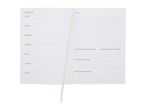 Open weekly planner with sections for daily tasks, a to-do list, and reflection.