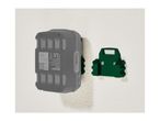 A gray Parkside battery pack mounted on a green wall holder.
