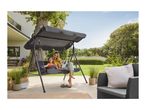 Mother and child on a garden swing seat with canopy, surrounded by garden furniture.