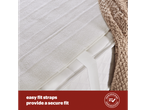 Mattress topper with elasticated straps for a secure fit, next to a knitted blanket.
