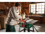 A woman uses a Parkside table saw in a workshop.