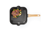 Grilani odrezak s povrćem u grill tavi.