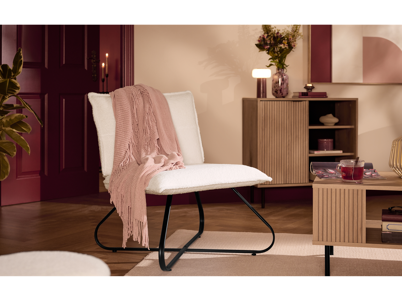 LIVARNO home chair with a pink throw in a living room setting.