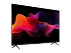Modern television with a vibrant, abstract wave pattern on the screen, viewed from an angle.