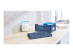 Two foldable storage crates, one filled with cleaning supplies, on a wooden countertop.