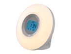 Round wake-up light with a digital display showing the time and date