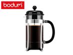 A classic glass French press coffee maker filled with freshly brewed coffee.