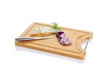 Bamboo chopping board with fennel, red onion, and a knife.