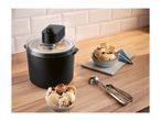 Ice cream maker on a wooden counter with bowls of ice cream and an ice cream scoop.