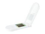 A white plastic handheld vegetable slicer.