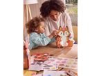 A mother and daughter decorate a unicorn fox-shaped paper lantern.
