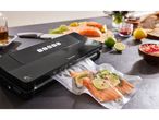A SilverCrest vacuum sealer is sealing a bag of salmon fillets with lime and dill.
