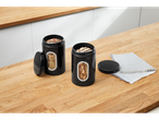 Two black SILVERCREST® storage containers with clear windows, one with herbs, one with cookies, on a wooden counter.