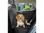 Beagle dog in a car seat cover, secured with a harness.