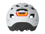 Rear view of a white bicycle helmet with an illuminated red LED light and a power button.
