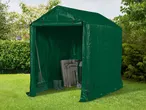 Green garden storage tent with a rake, boots, and folded chairs inside on a lawn.