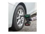 Person using a Parkside impact wrench to change a car tire.
