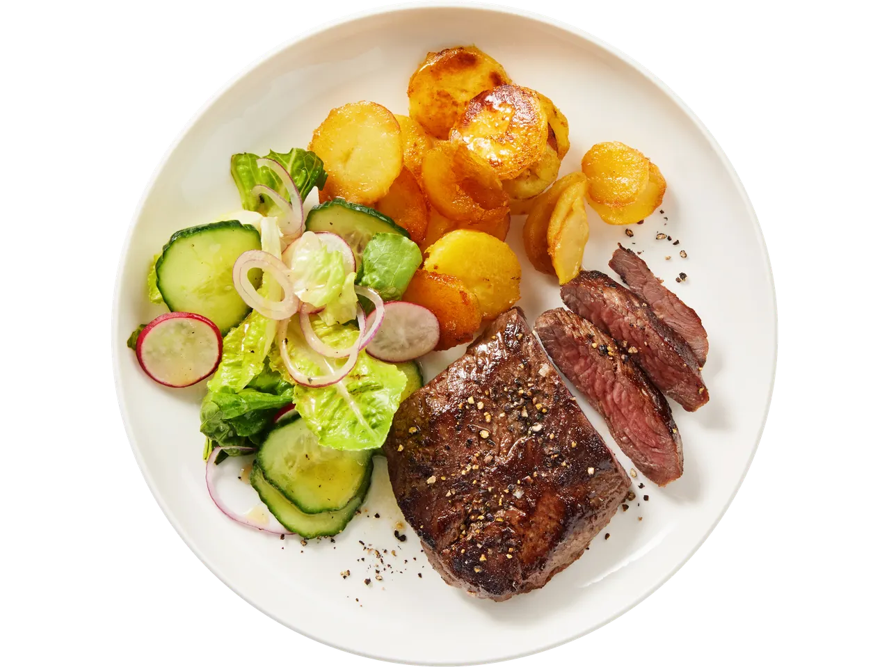Steak, roasted potatoes, and salad: a tasty meal.