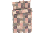 Patchwork-style bedding set in pink and purple tones, including a duvet cover, pillowcases, and a bolster.