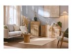 Living room with light wood furniture, a beige sofa, and a cream rug, bathed in natural light.