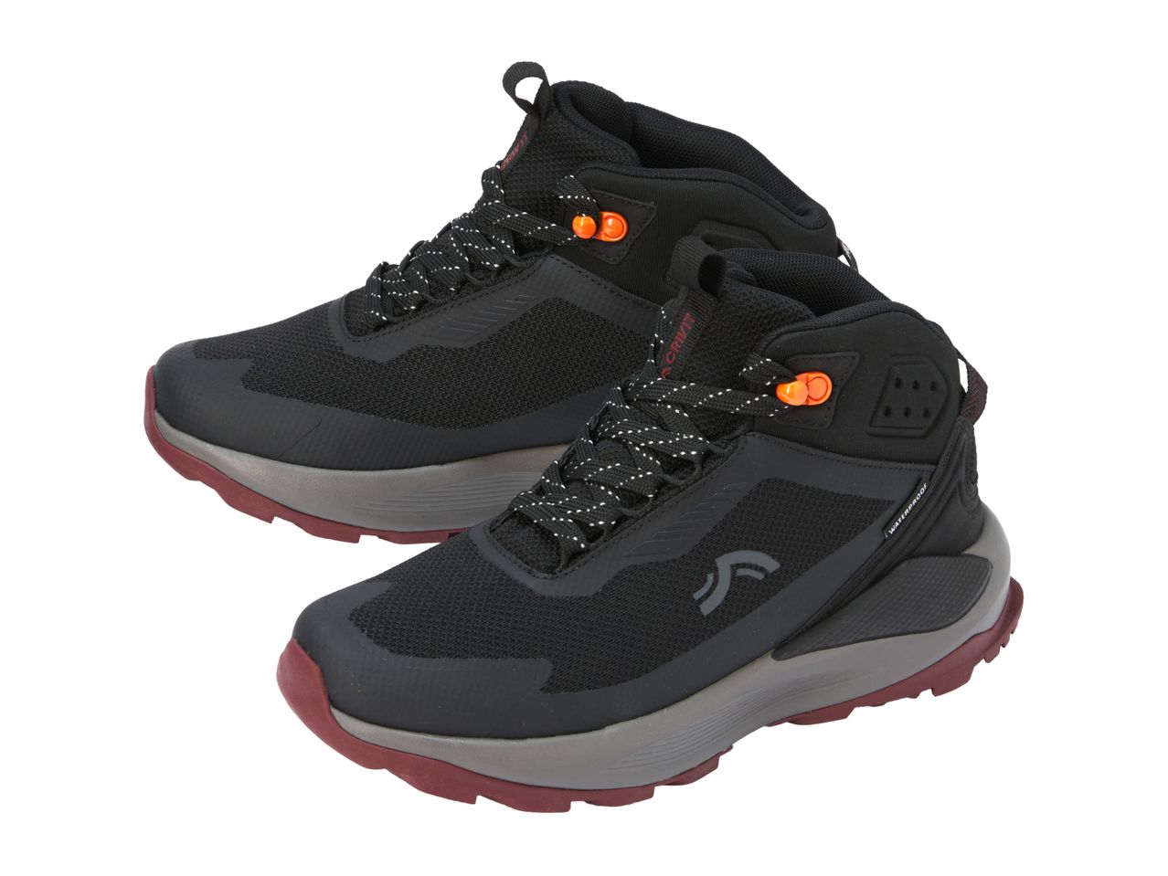 Pair of black hiking boots with orange accents and a grey and red sole.