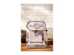 Pink SilverCrest espresso machine with a temperature gauge on a wooden counter.