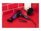 Hair dryer with diffuser and hair clips on a red surface with red tiled wall.
