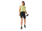 Woman in sportswear: top, shorts, and Crivit shoes.