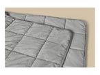 Grey quilted weighted blanket with a soft plush cover