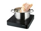 Stainless steel pot with boiling pasta on a black induction hob with digital display.