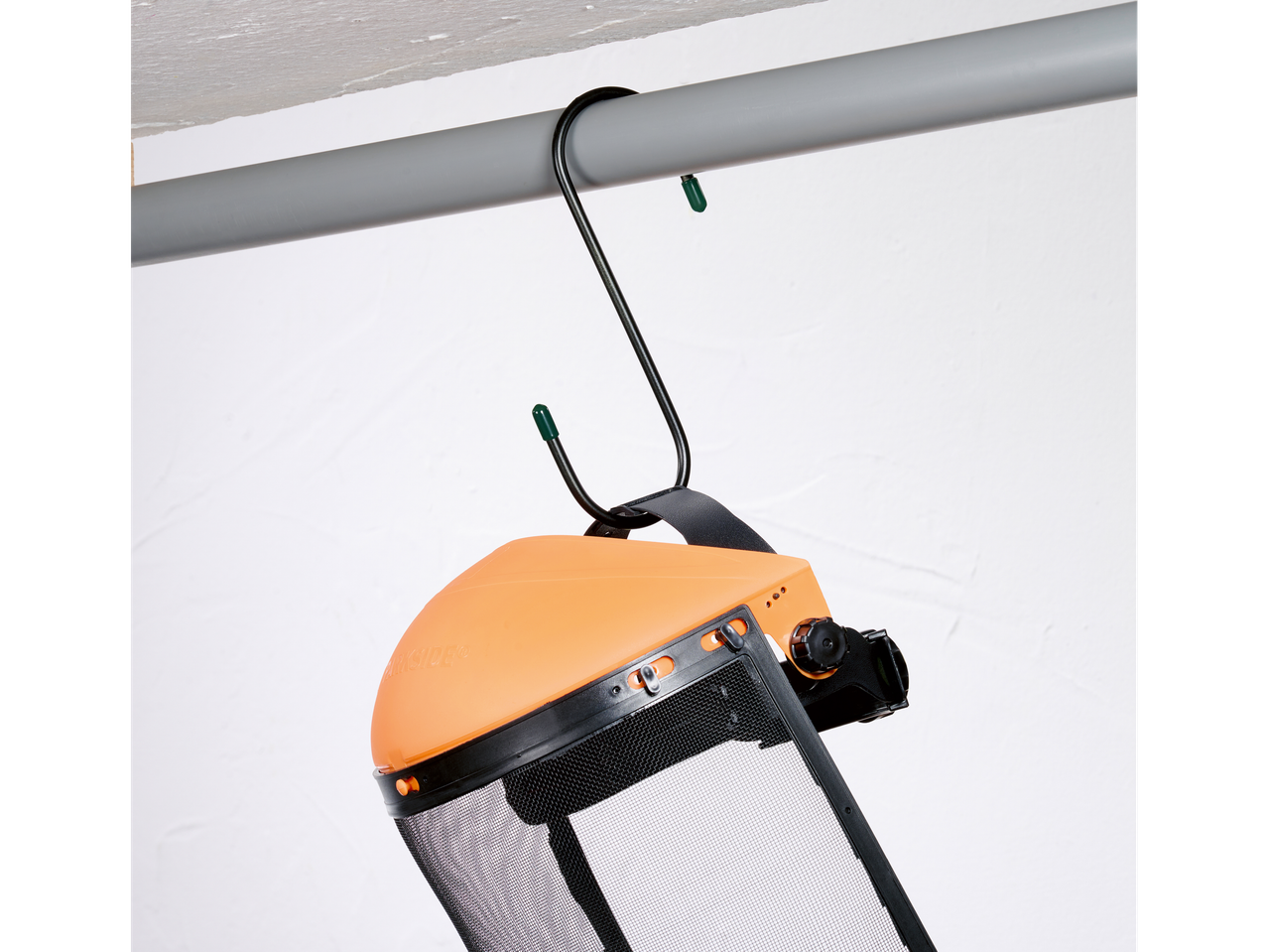 Protective face mask and hook hanging on a pipe.