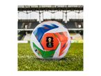 Soccer ball with colorful patterns on a green field in a stadium