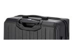 Close-up of the top of a black hard-shell suitcase with a retractable handle and a side handle.