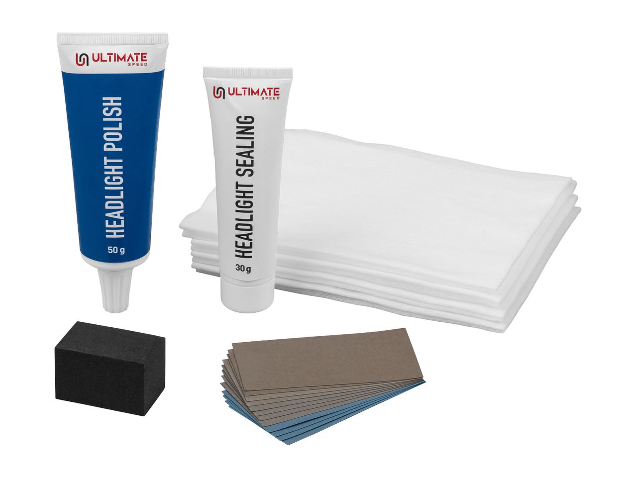 Headlight restoration kit with polish, sealant, sandpaper, cloths, and a sanding block.