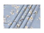 Light blue fabric with a delicate white cherry blossom pattern