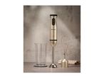 Silvercrest hand blender with whisk attachment and measuring cup on a grey background.